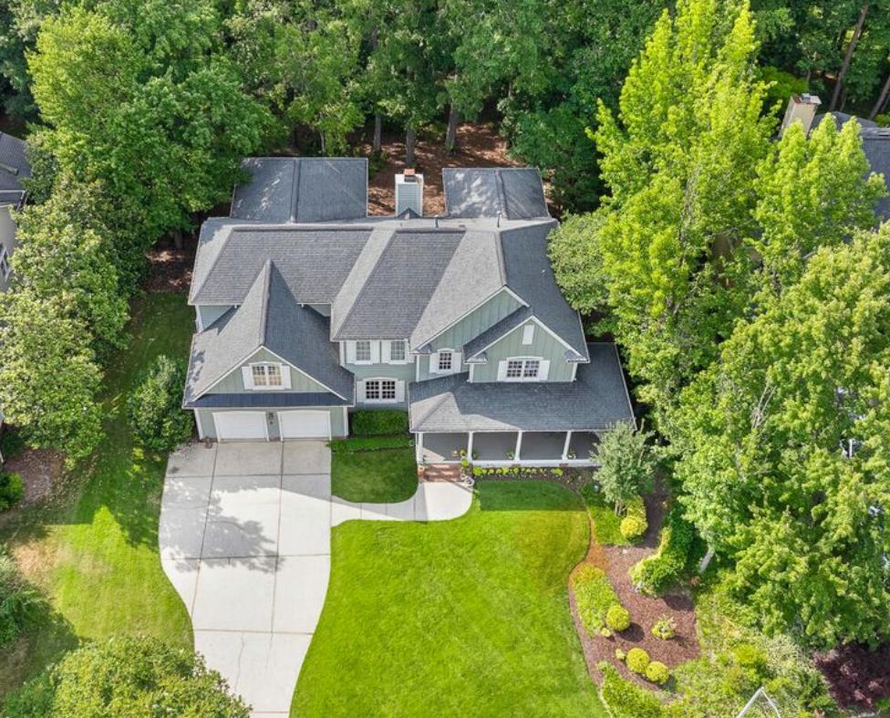 Aerial view of an established Raleigh neighborhood home framed by mature trees