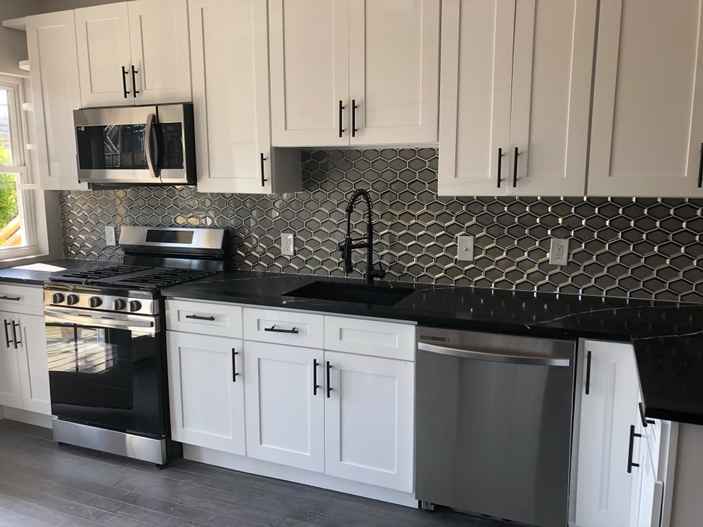 Custom Kitchen with Geometric Tile & Dark Countertops — Kitchens