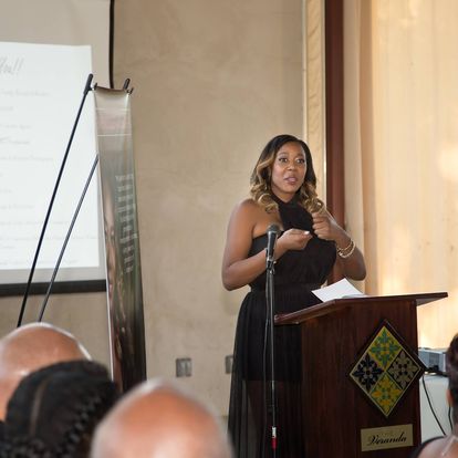 Gwendolen Wilder speaking live at podium with microphone