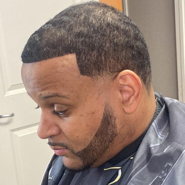 Sharp edge-up taper haircut with precision sculpted beard line