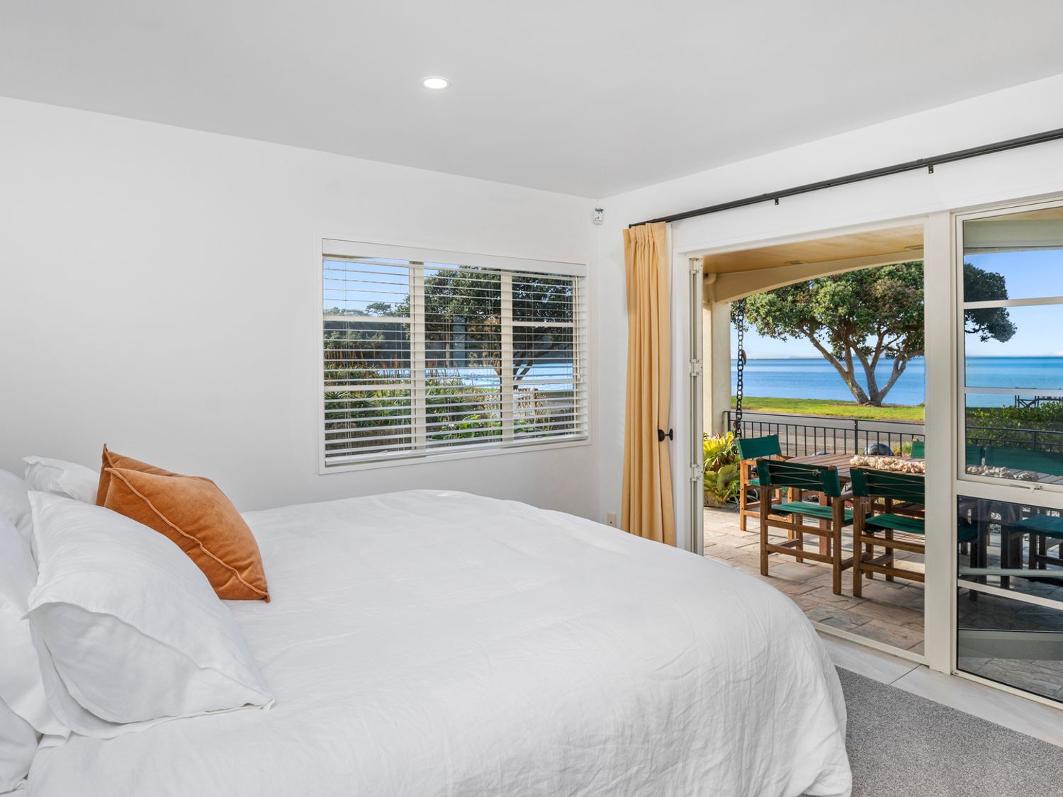 Bedroom with a superking bed and a view toward Arkles Bay
