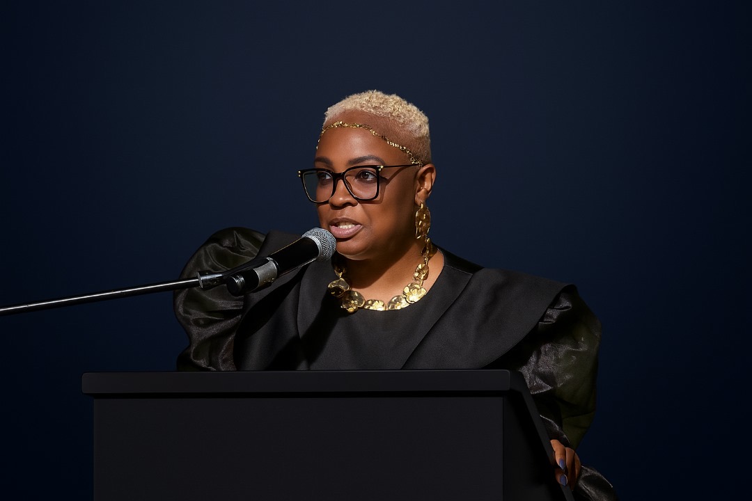 Queen Shanta Lana Hereford addressing an international audience from a podium
