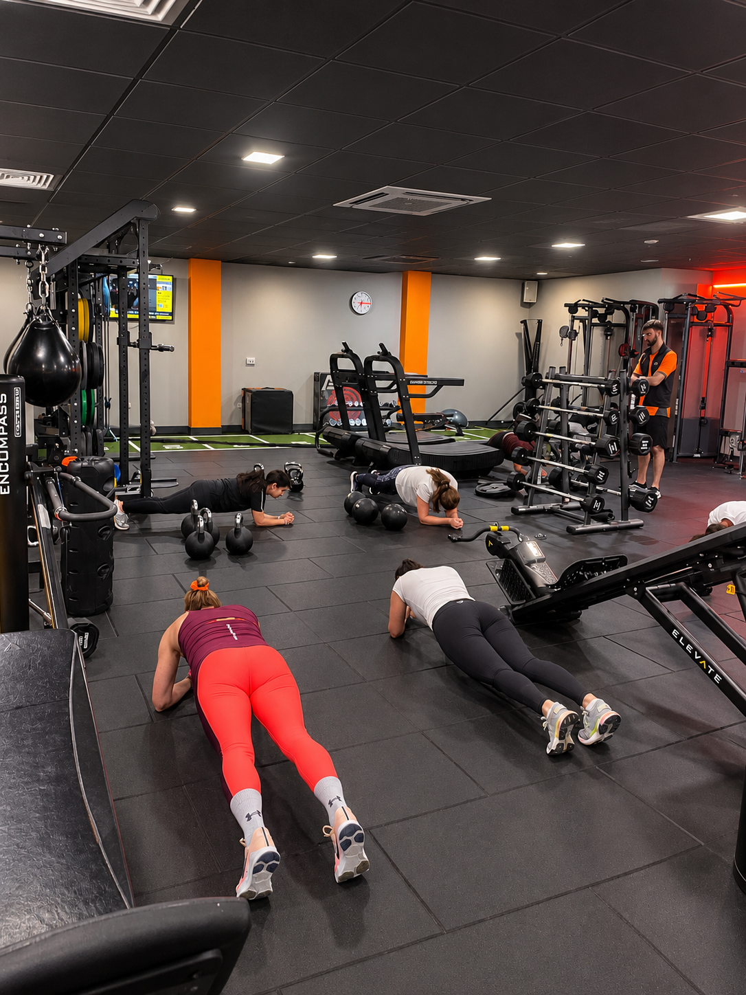 Couples personal training session in Reading with dumbbells and kettlebells in a dark gym