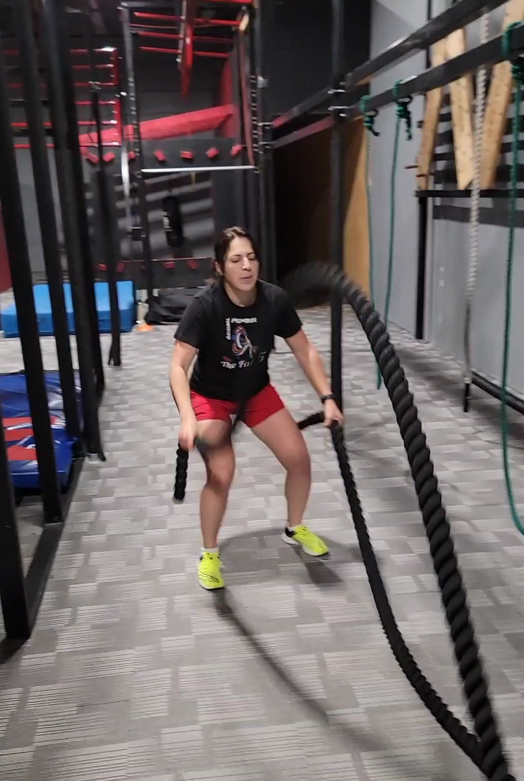 Adult training with battle ropes at GRIT