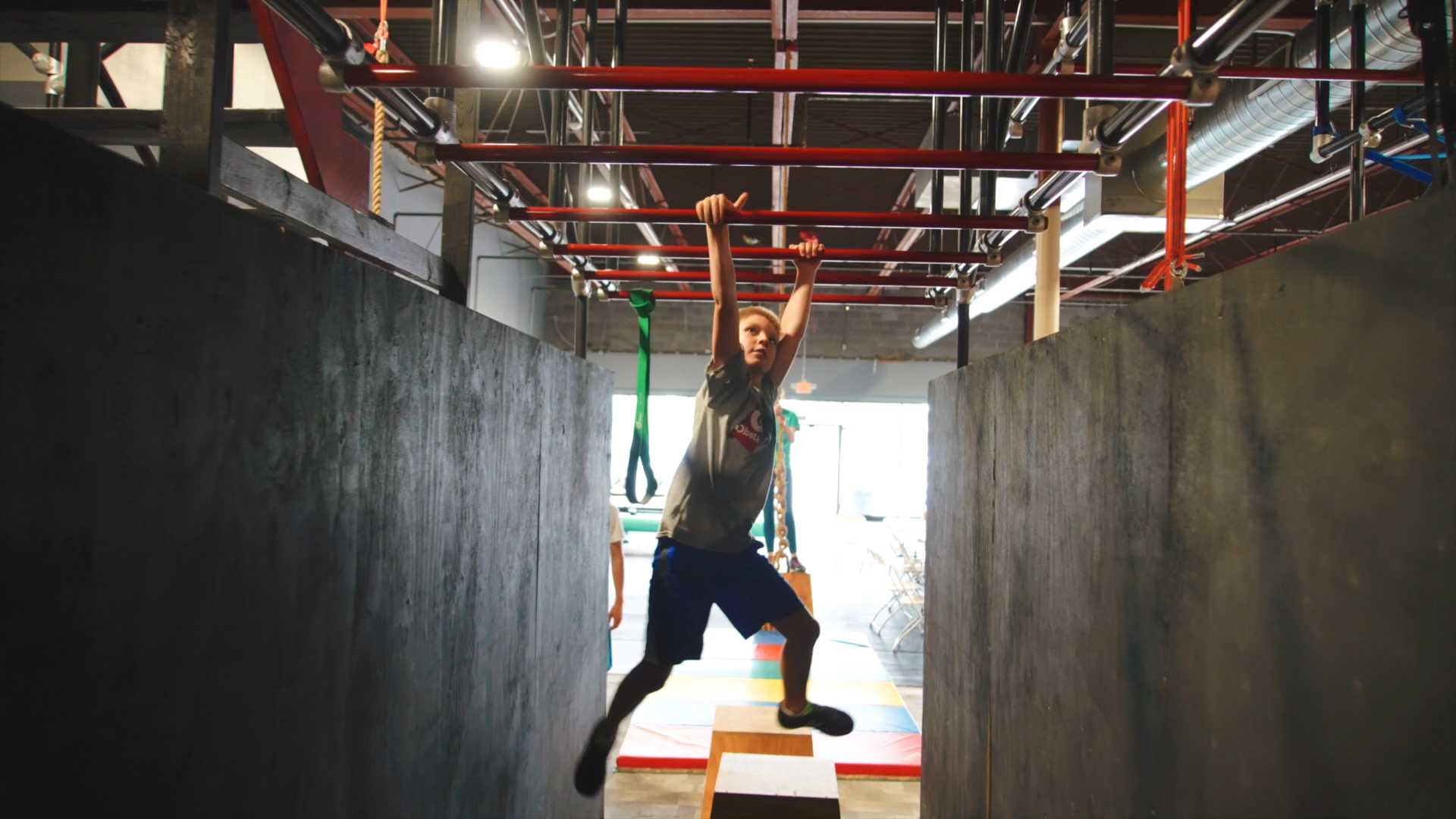 Youth obstacle course monkey bar training
