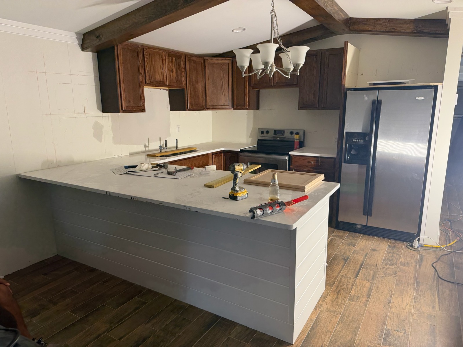 Warm Wood Cabinetry with Custom White Shiplap Island & Quartz Tops