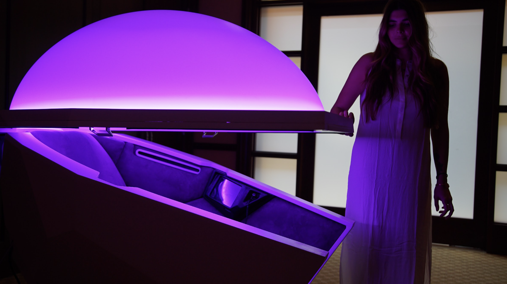 Somadome illuminated with purple light as guest prepares for a session