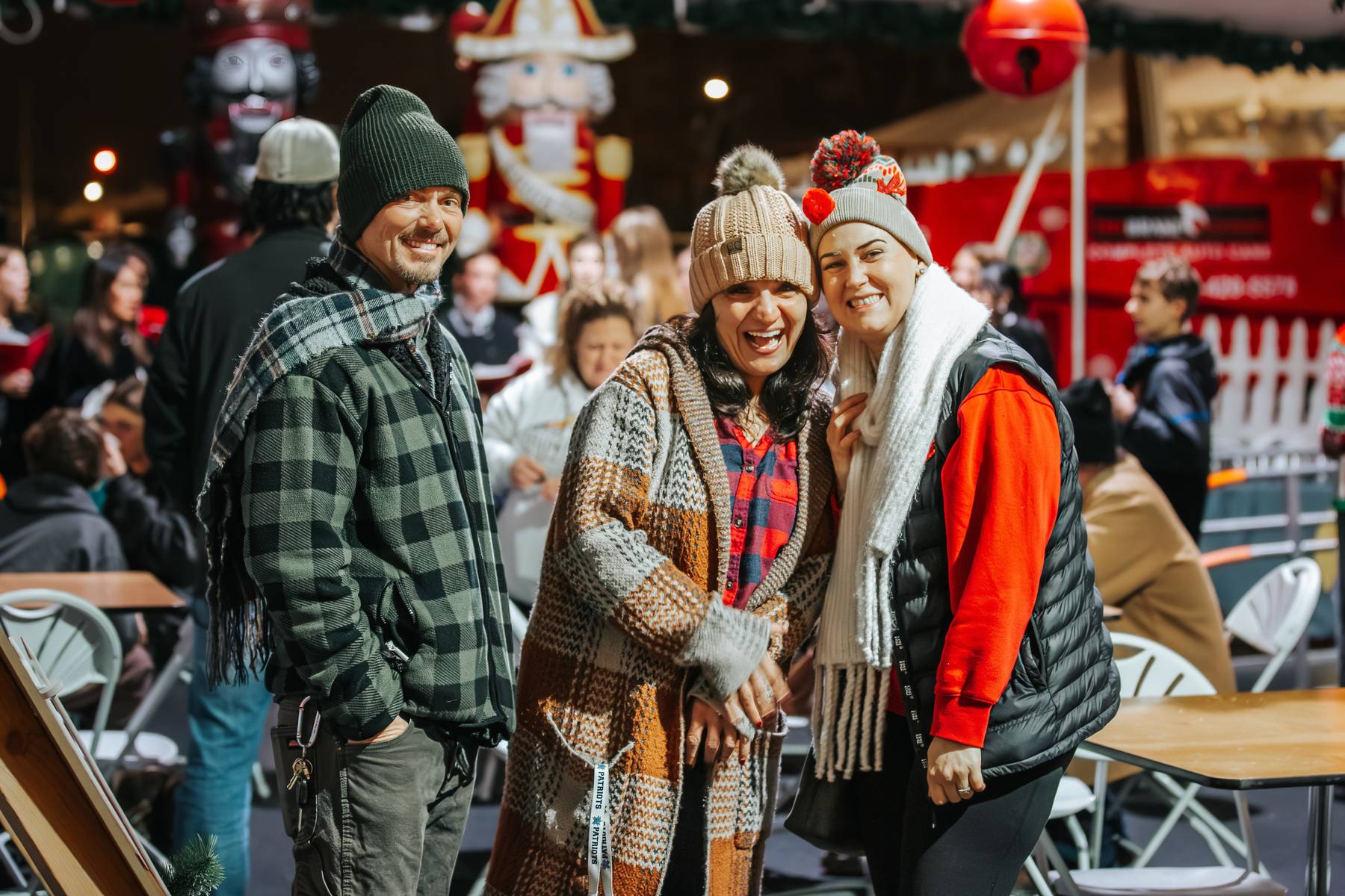 Attendees in cozy winter hats and beanies enjoying the holiday festivities