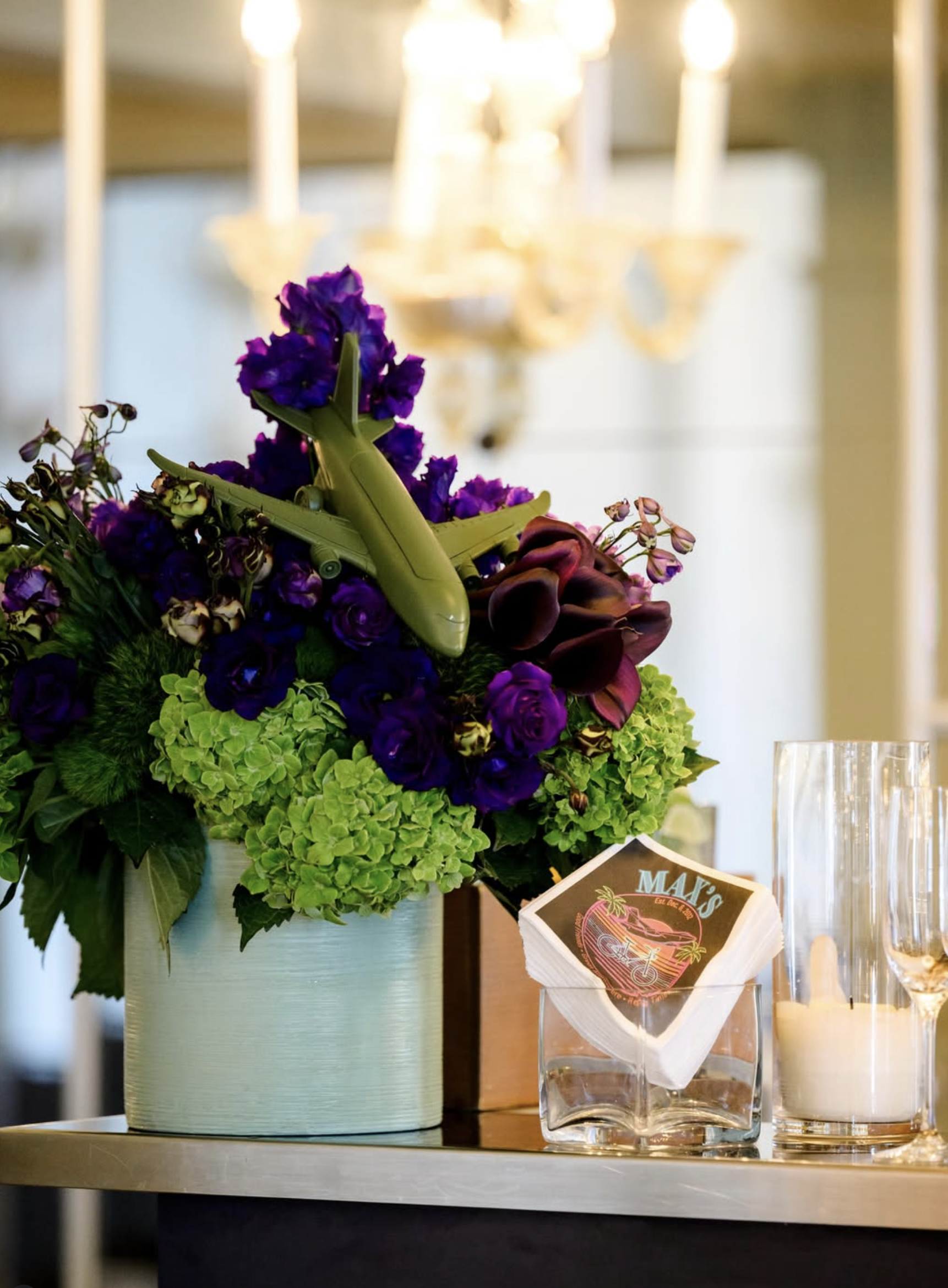 Bespoke purple floral arrangement with custom aviation motif, hydrangea and calla lilies