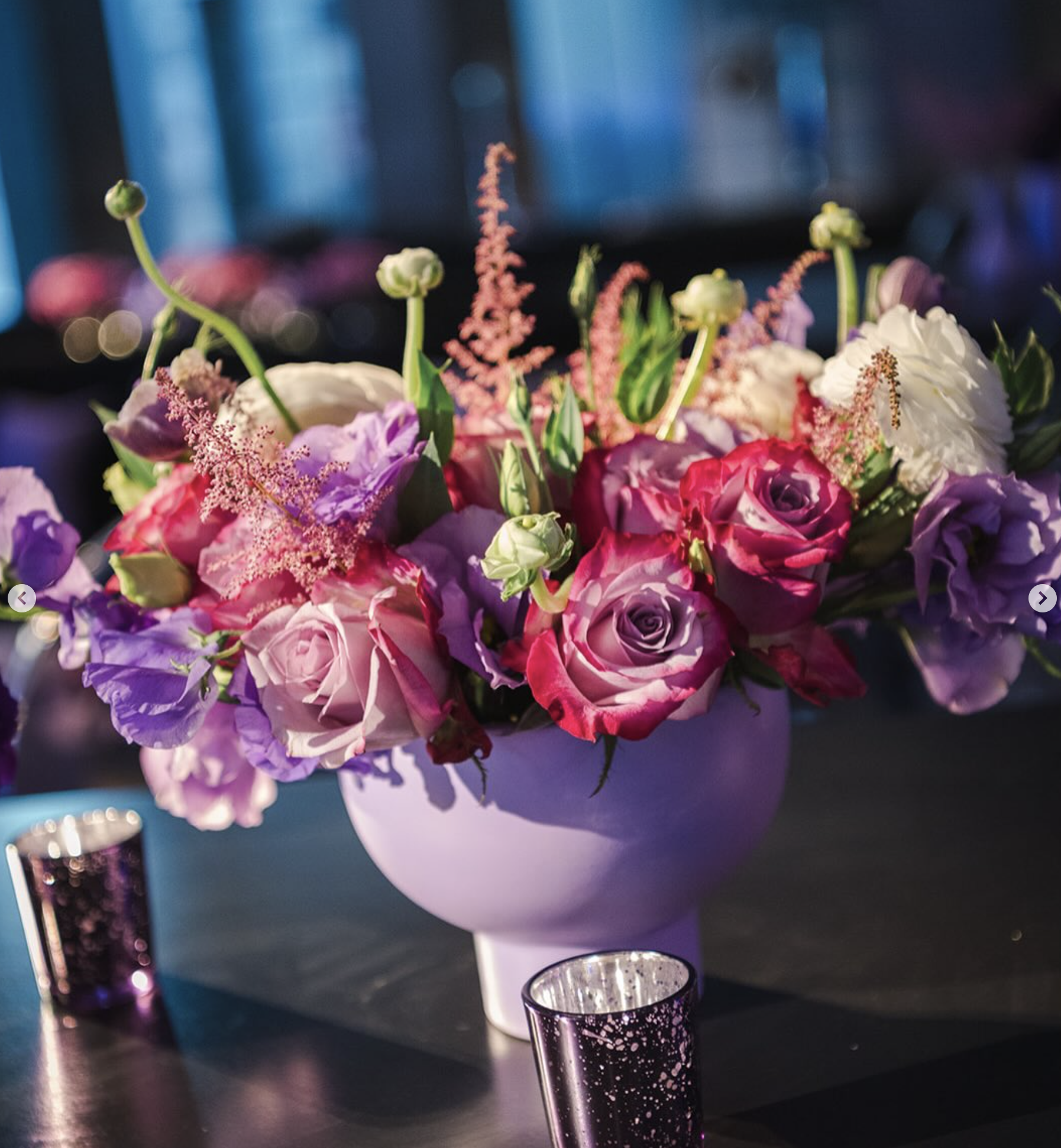 Atmospheric floral arrangement by Creative Floral Designs on an event tabletop