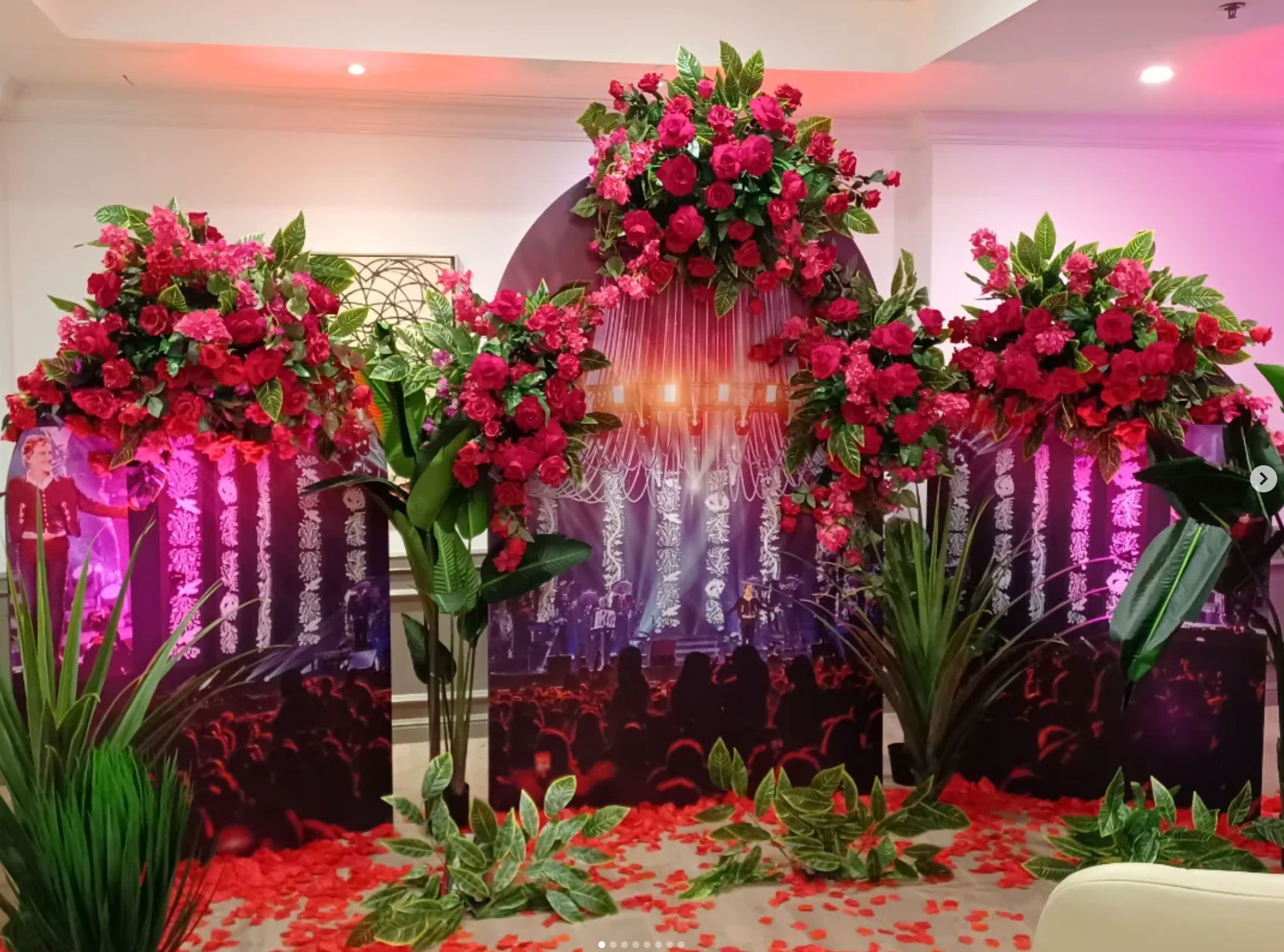 Theatrical crimson floral arch installation