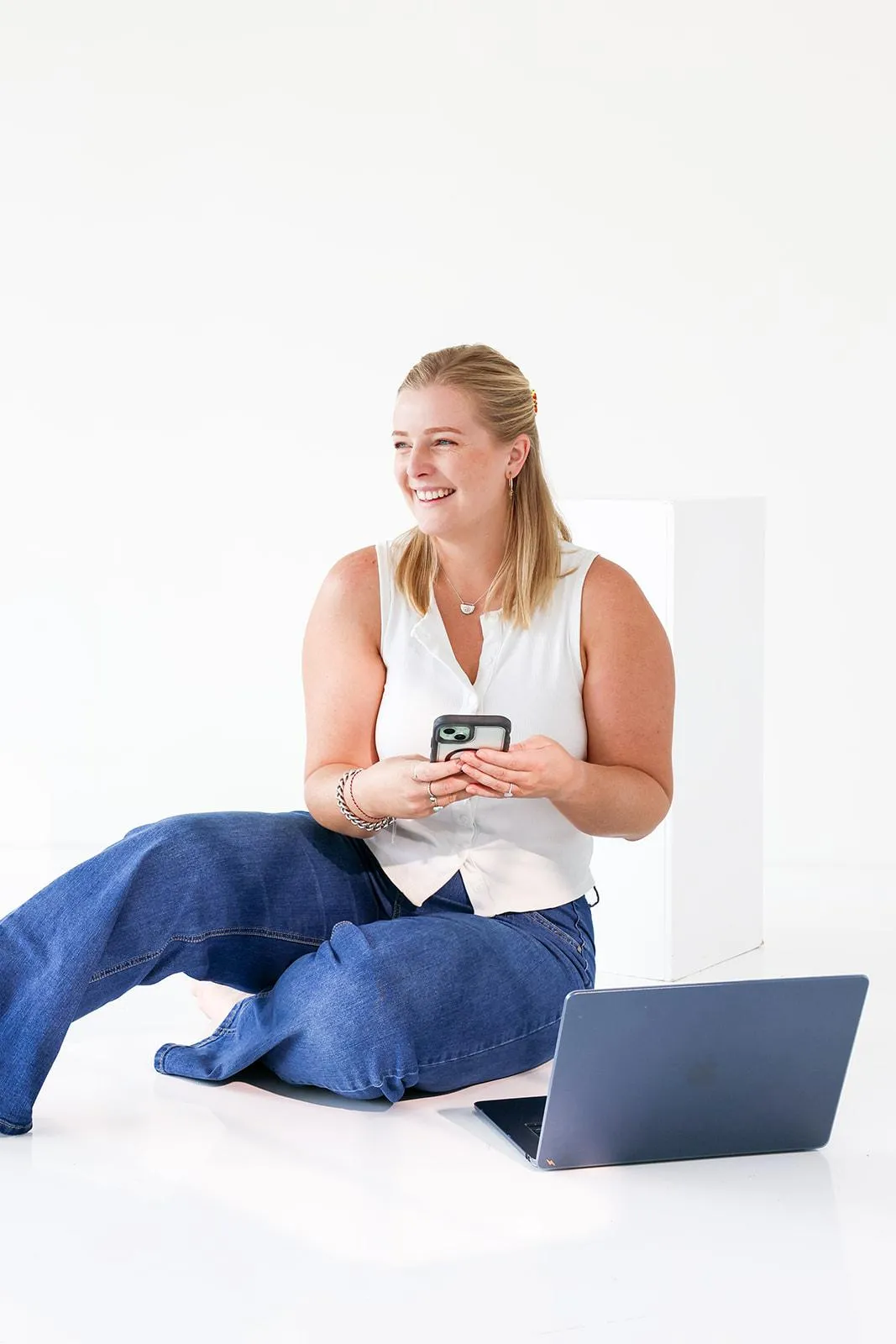 Paige smiling with laptop and phone