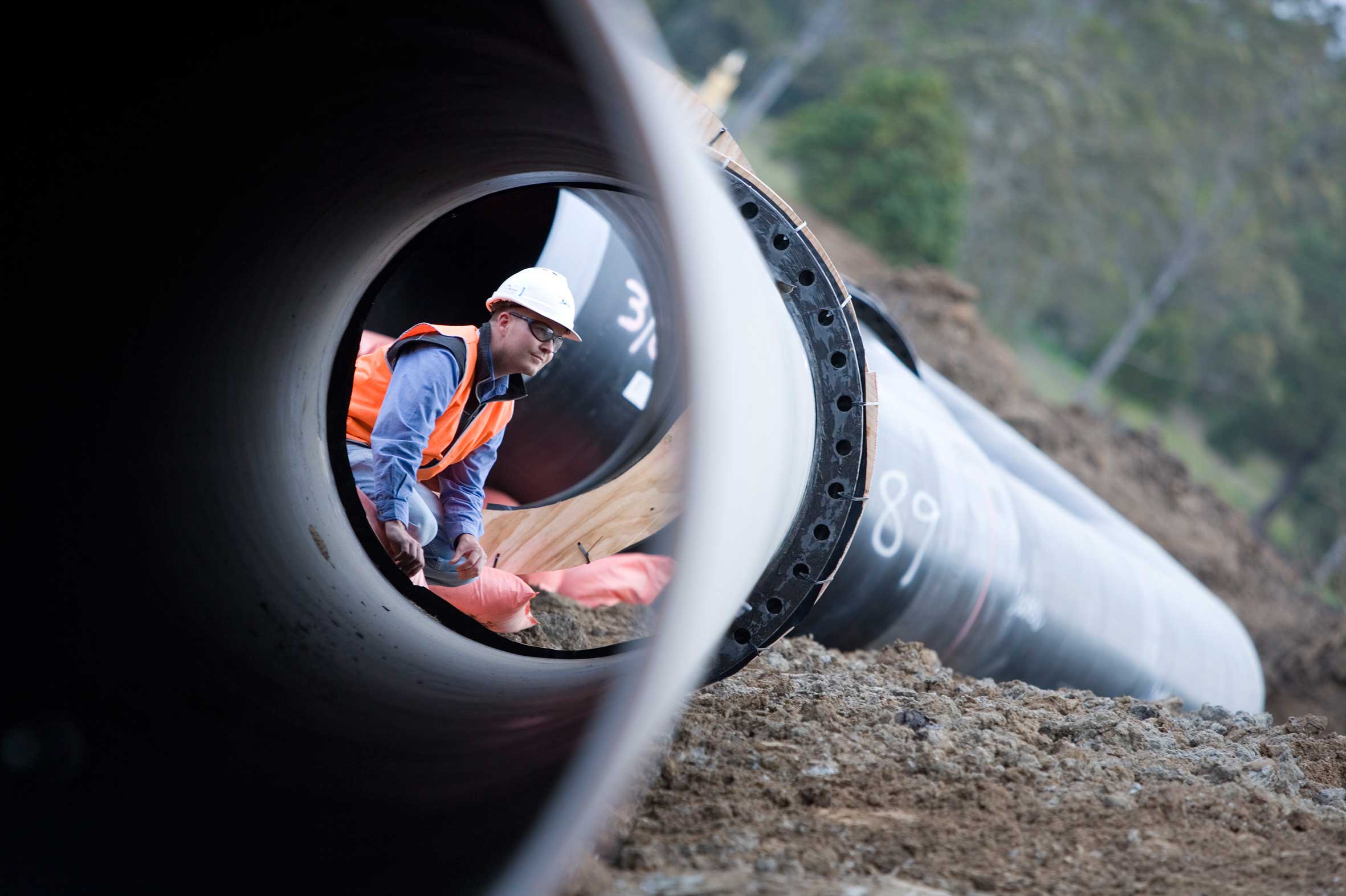 Bokano pipeline inspection engineer performing quality and safety checks inside large diameter steel pipe