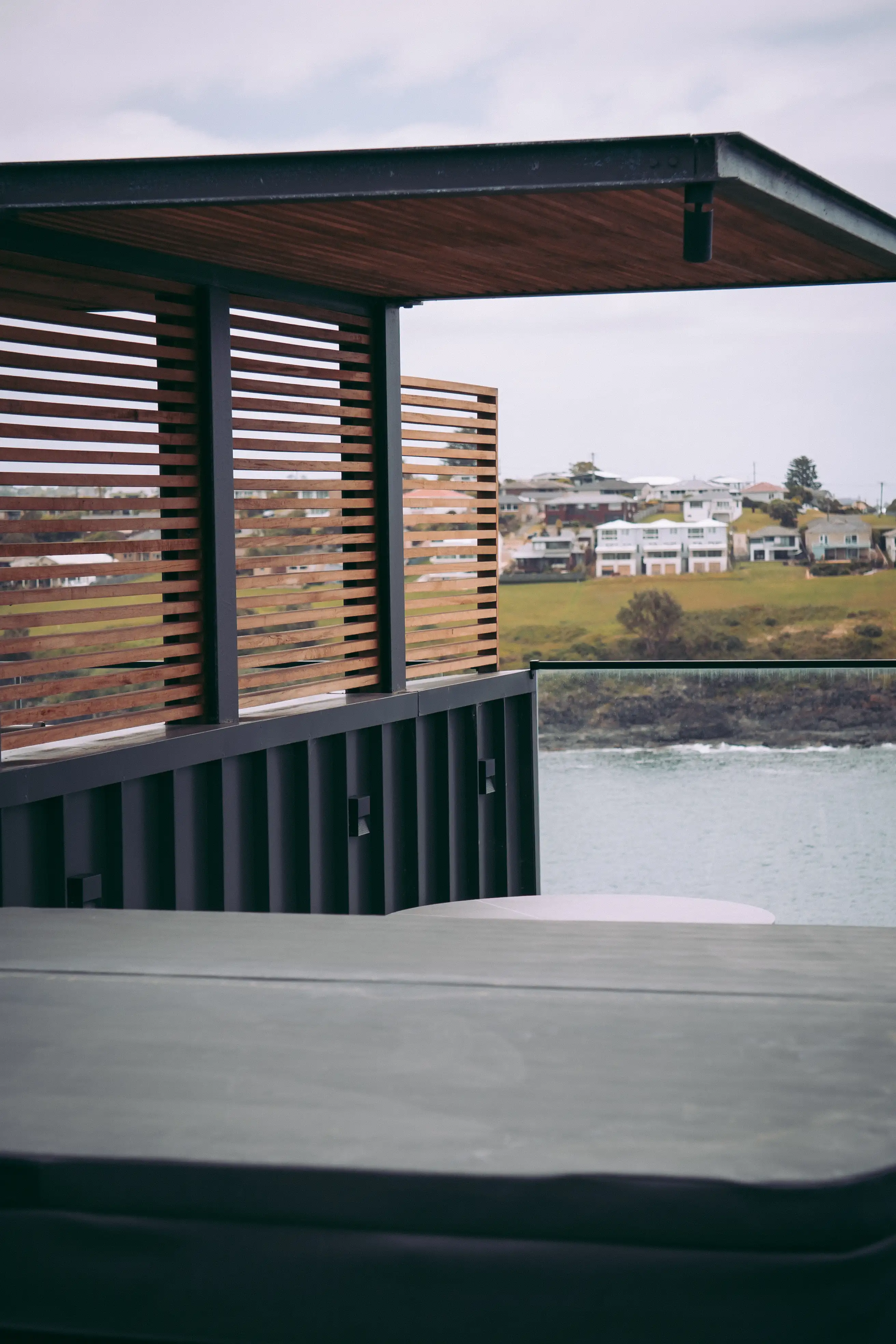 Kiama Duplex custom pergola, timber batten screens and spa deck overlooking the coast