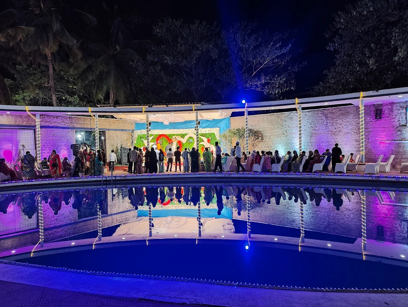 Evening reception on the poolside lawn with illuminations