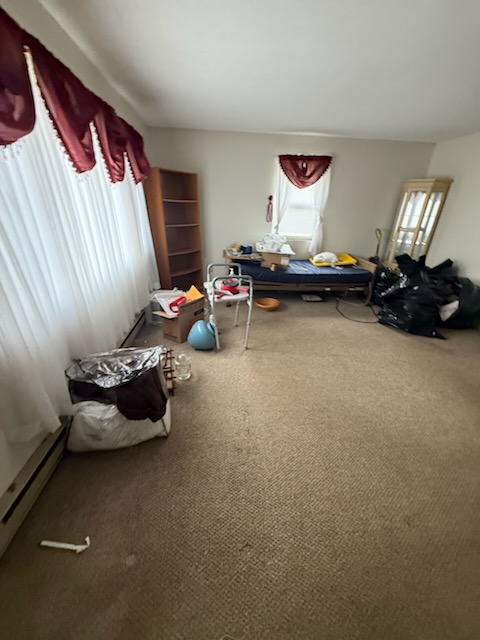 Bedroom and estate cleanout with hospital bed, bookcase, hutch and bagged belongings in Springfield MA