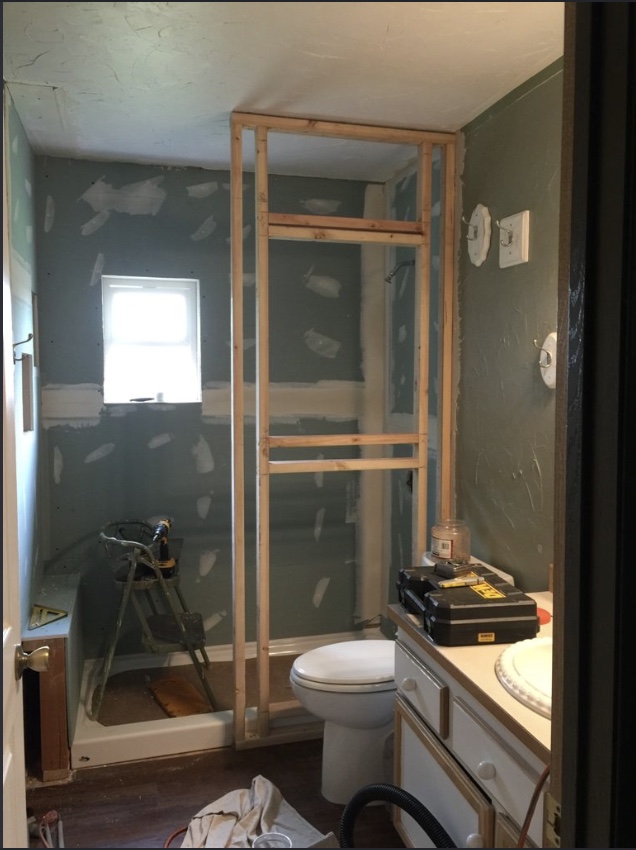 Walk-in shower framing and rough-in installation in progress