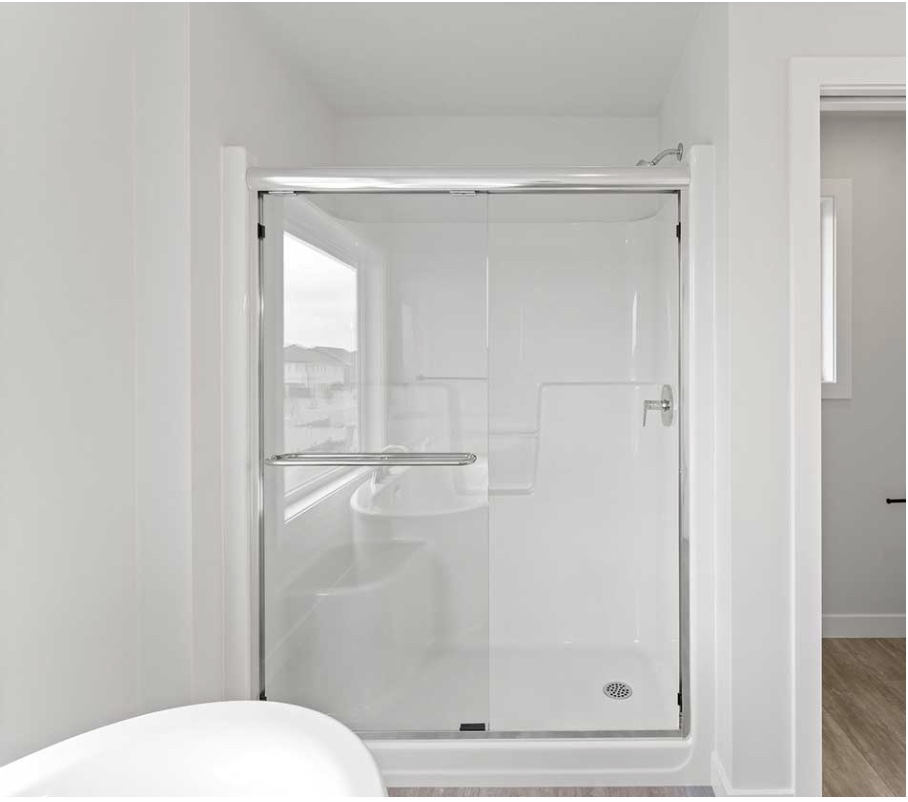 One-piece walk-in shower enclosure with glass doors and built-in bench