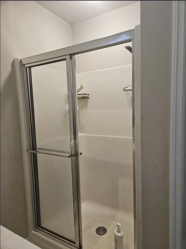 Walk-in shower with framed sliding glass doors