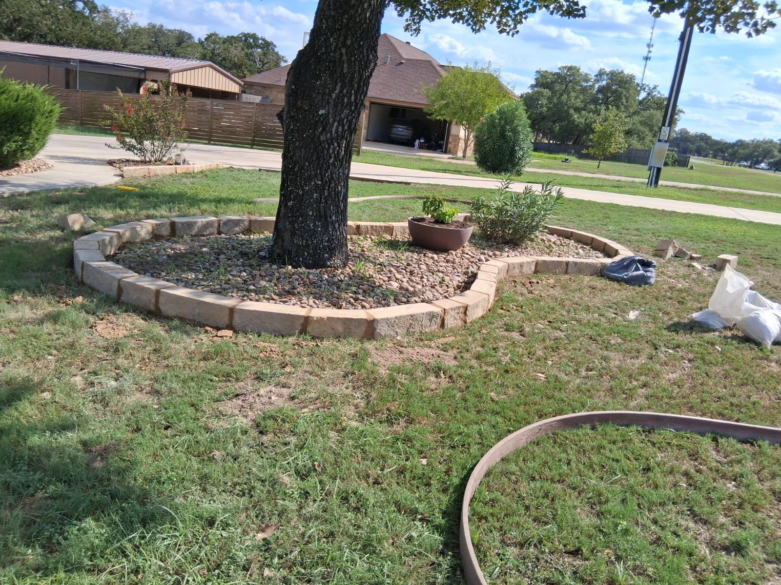 Curved stone retaining wall and ground leveling work in San Antonio, TX