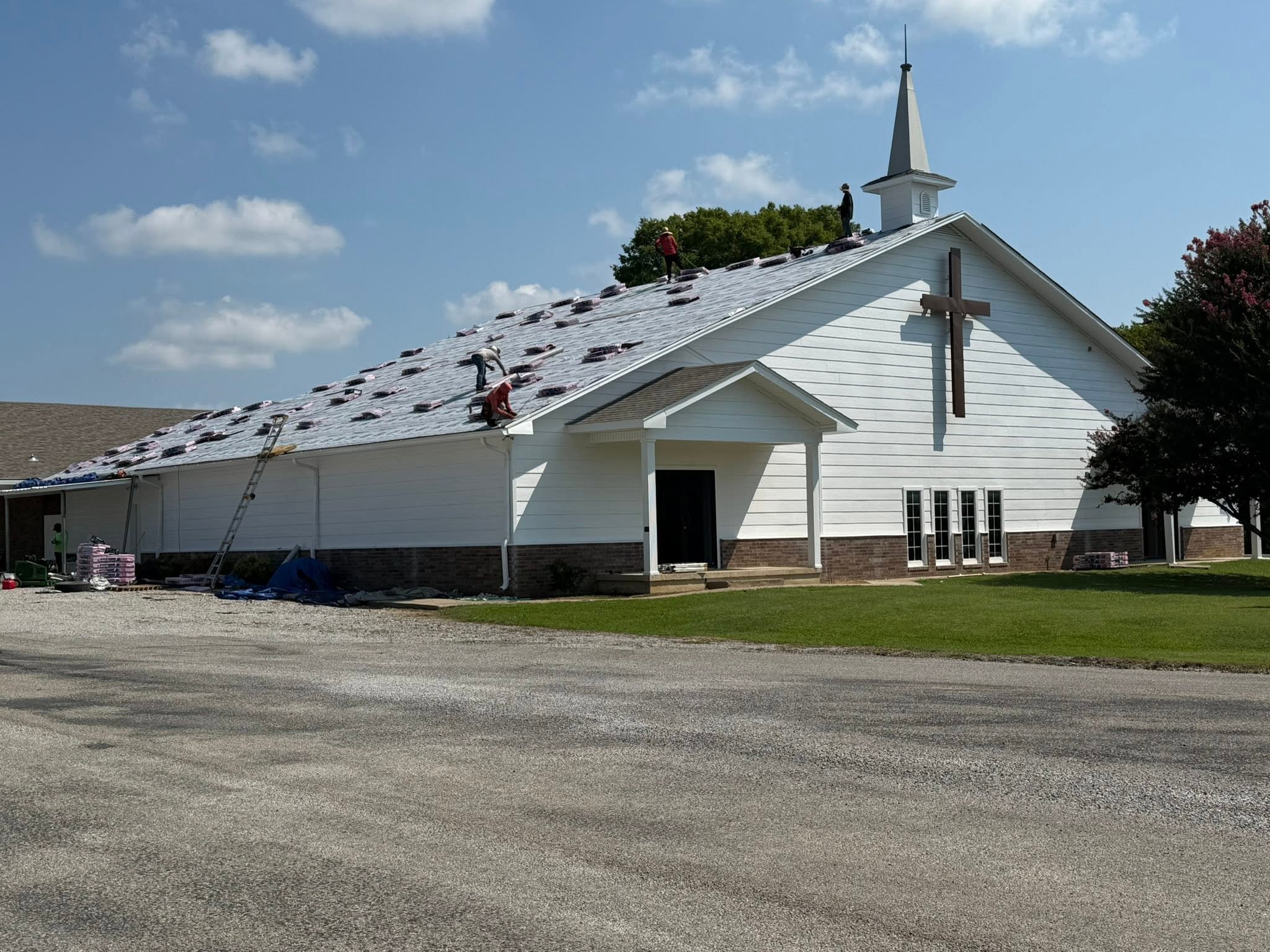 J & H roofing crew replacing a large steep-slope roof in the Texoma area