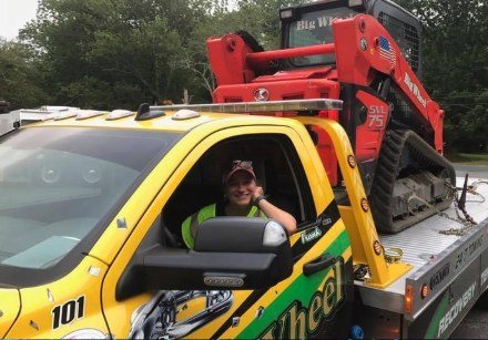 Jade behind the wheel of a Big Wheel Towing rollback