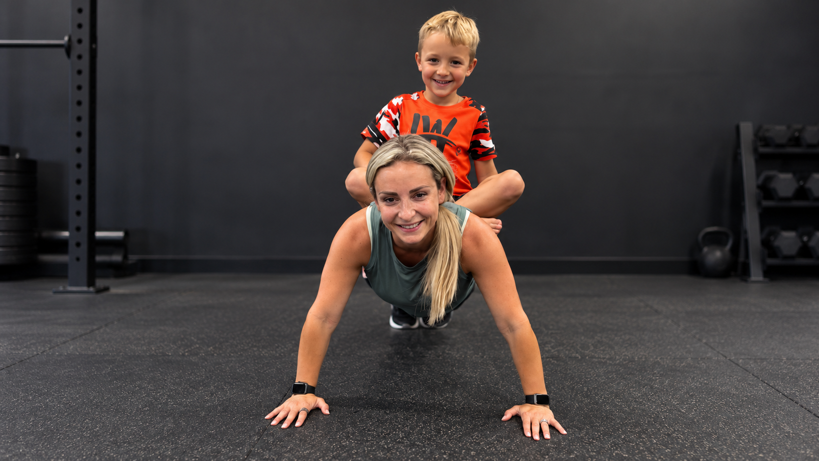 Strong Mom Project participant smiling during workout with son