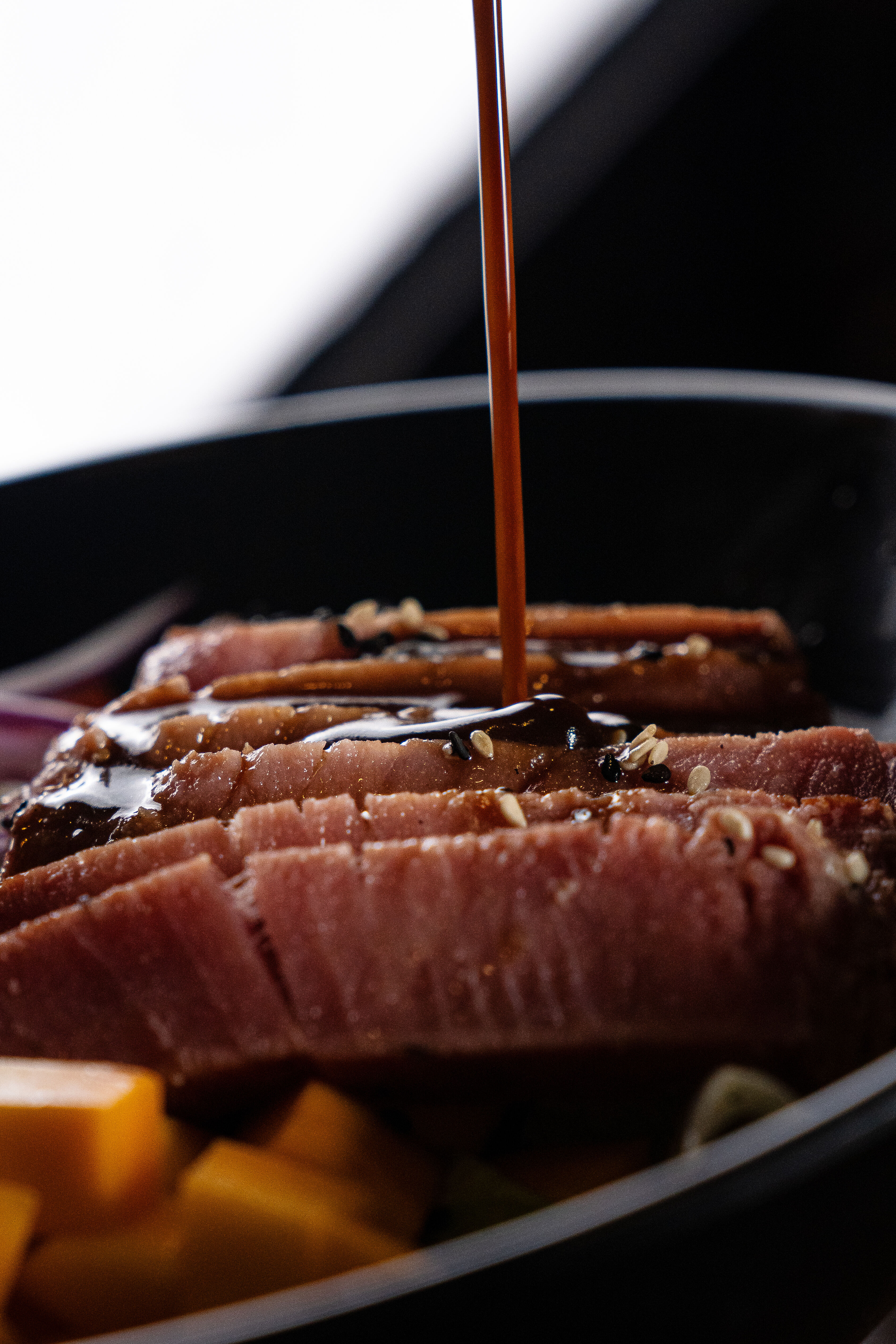 Chef Drizzling Asian Soy Glaze on Seared Tuna Steak