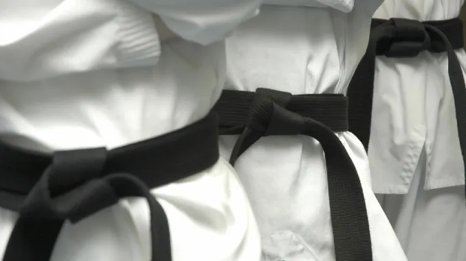 Black Belt candidates in traditional white Tae Kwon Do dobok uniforms