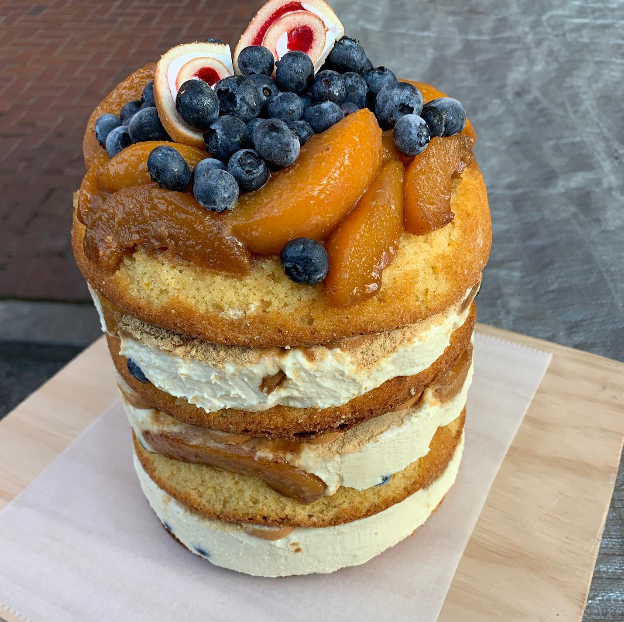 Hand-stacked caramelized peach & blueberry diplomat layered cake