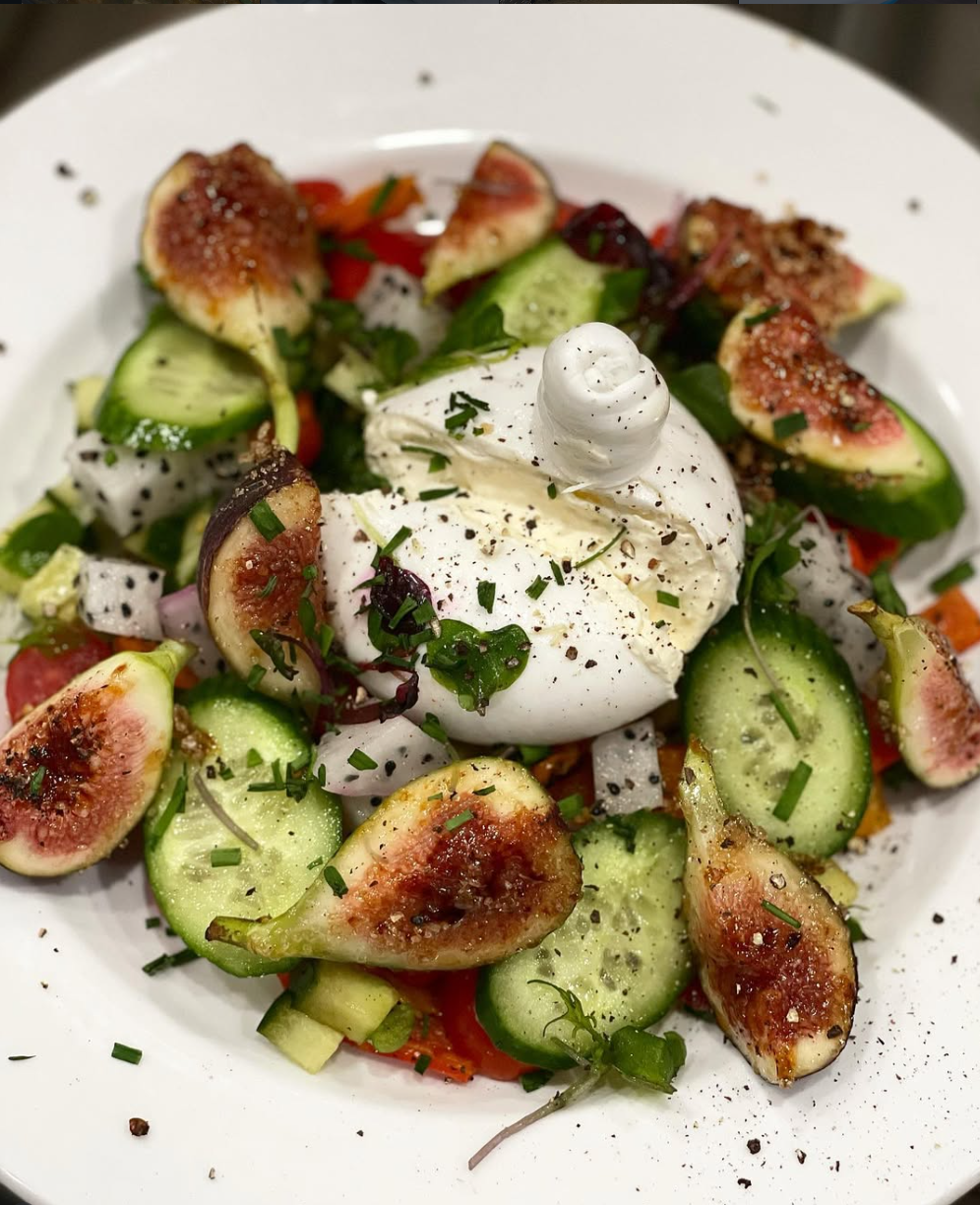 Truffle burrata with caramelized mission figs, dragonfruit & fresh garden herbs