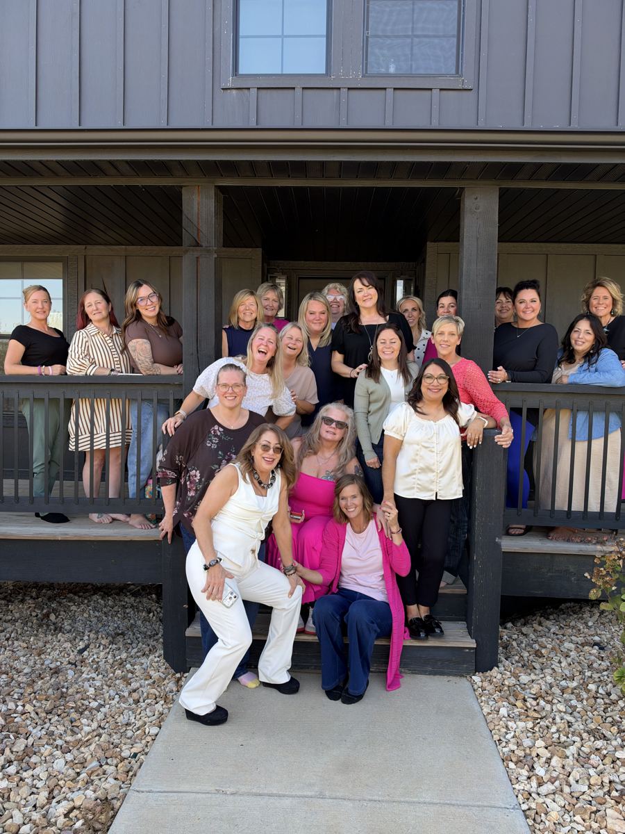 Jess and attendees smiling together on the porch at the Branson Shoulder to Shoulder event