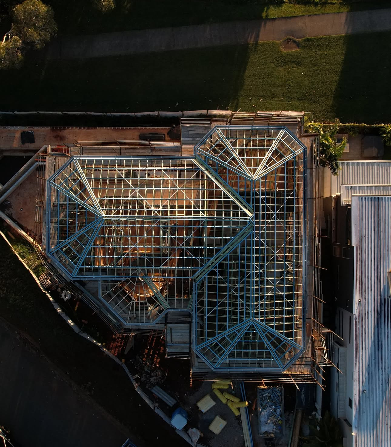 6 Broadwater Tce Redland Bay - Bird's-eye aerial view of complex multi-pitch hip and valley roof truss geometry overlooking Moreton Bay