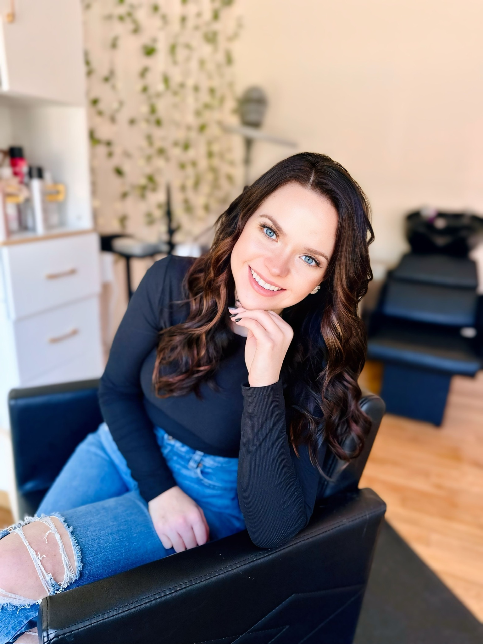 Kalene smiling in her salon styling chair at Hair By Kalene