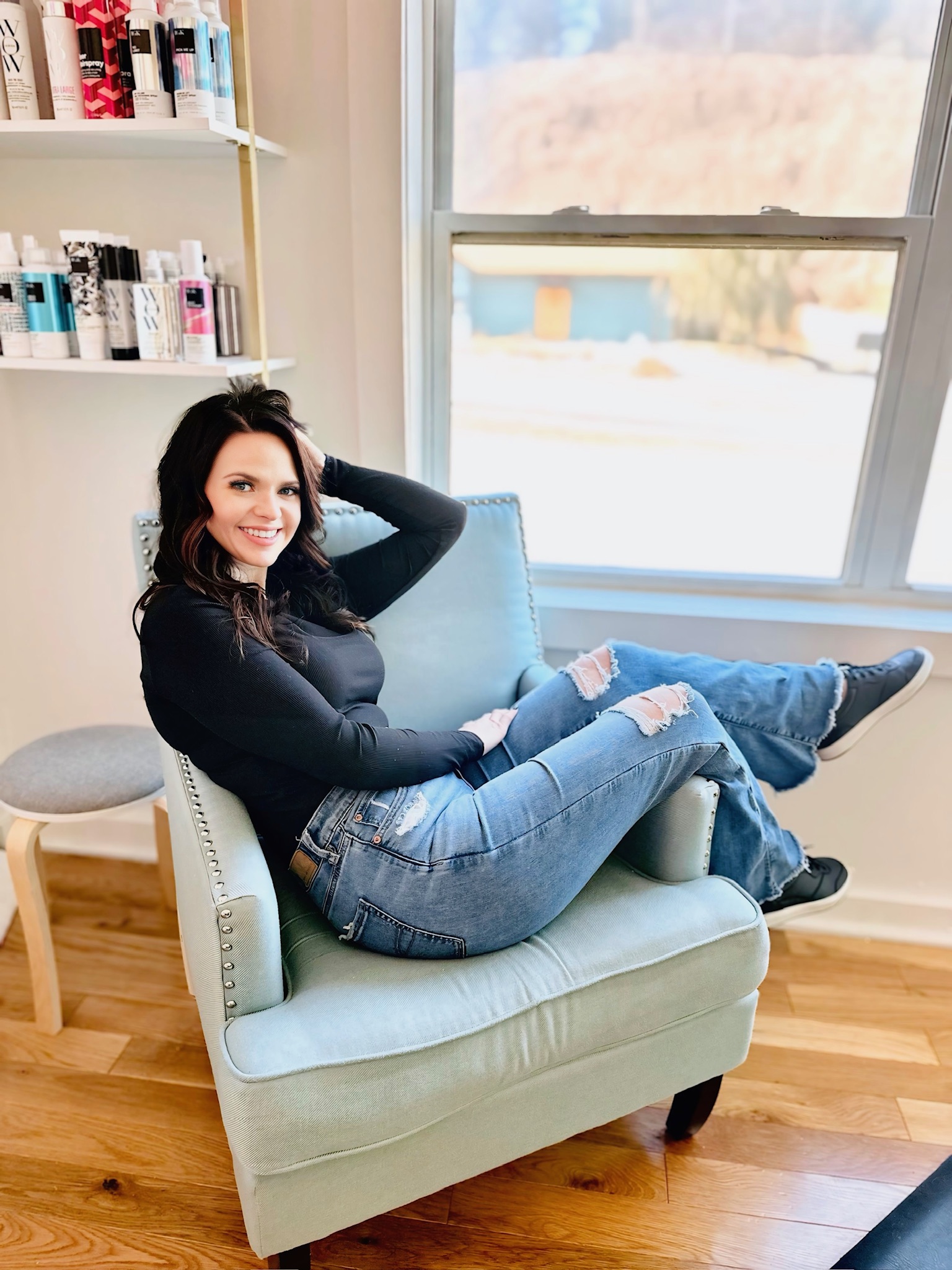 Kalene, owner and stylist behind Hair By Kalene, relaxing in her salon chair