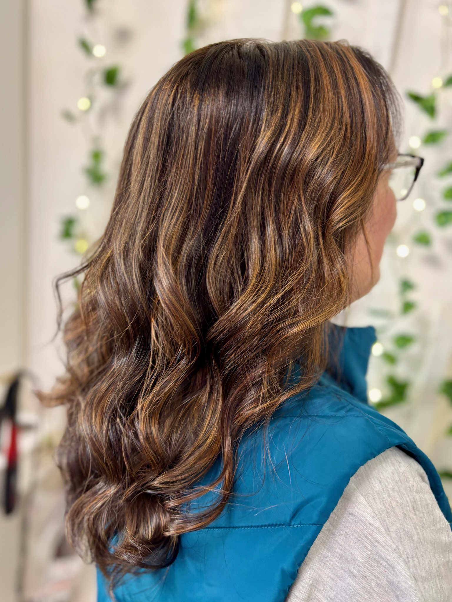 Rich brunette with warm caramel balayage and long voluminous waves by Kalene