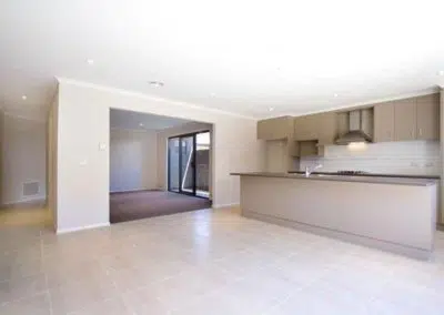Open plan kitchen renovation with island breakfast bar, modern cabinetry and sliding patio doors