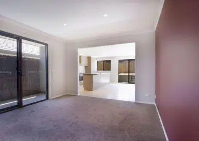 Renovated living and kitchen extension opening onto outdoor courtyard with sliding glass doors