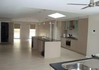Spacious open plan kitchen renovation with island bench, skylight and stainless steel appliances