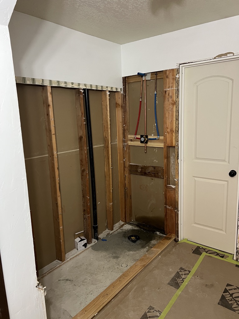 Bathroom framing and plumbing rough-in before tile installation