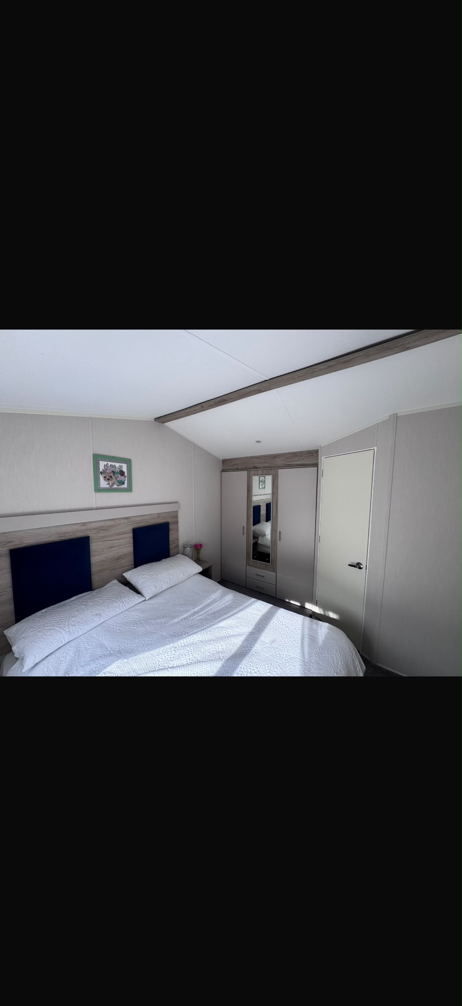 Double bedroom with bedside tables and wardrobe storage