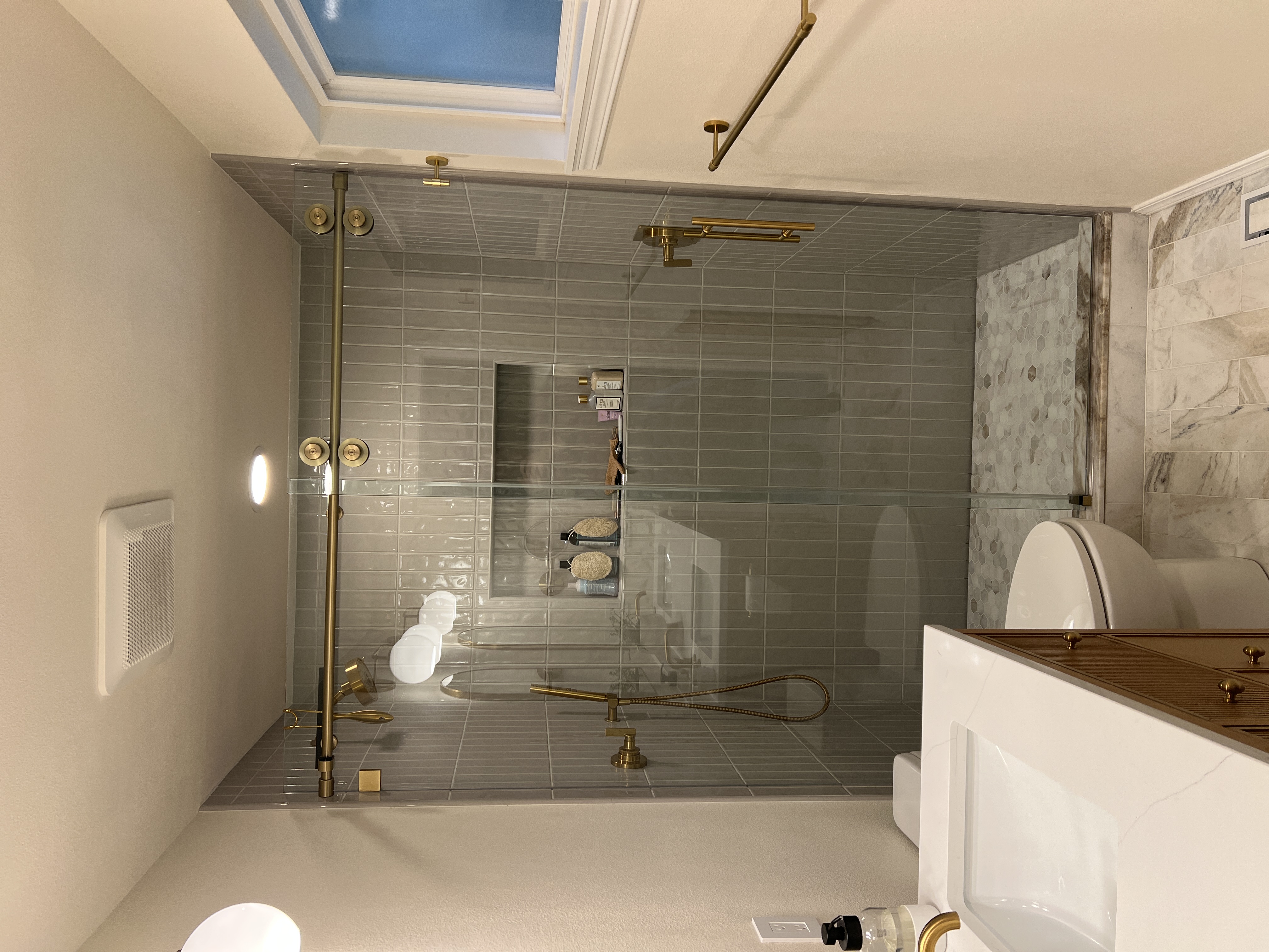 Vertical Green Subway Tile Shower with Gold Trim