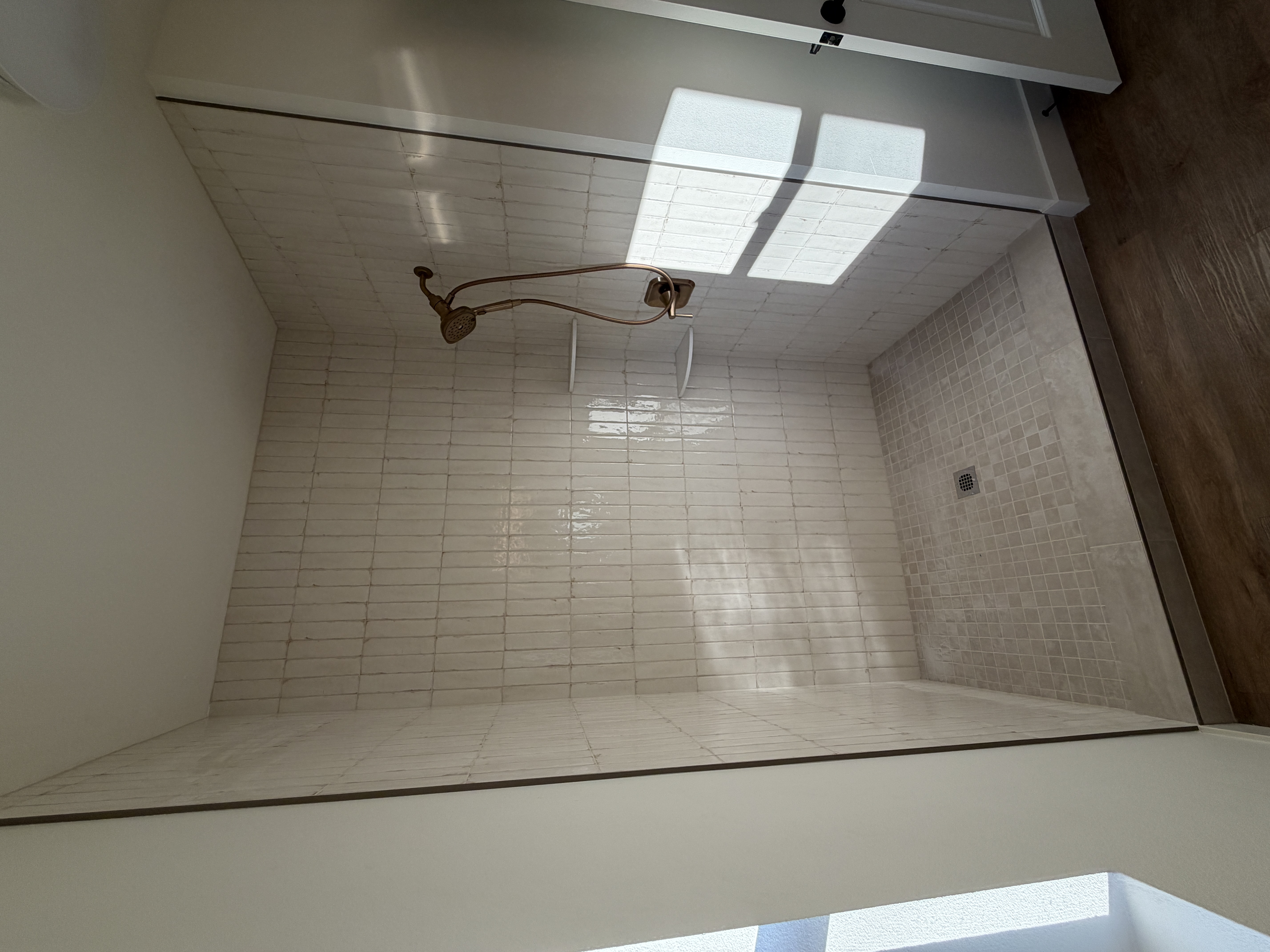 Curbless Walk-In Shower with Bronze Hardware