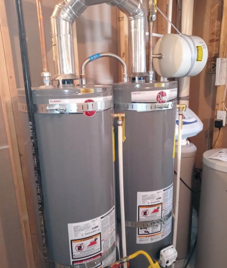Two gas water heaters with an expansion tank installed side by side in a Northern Utah home