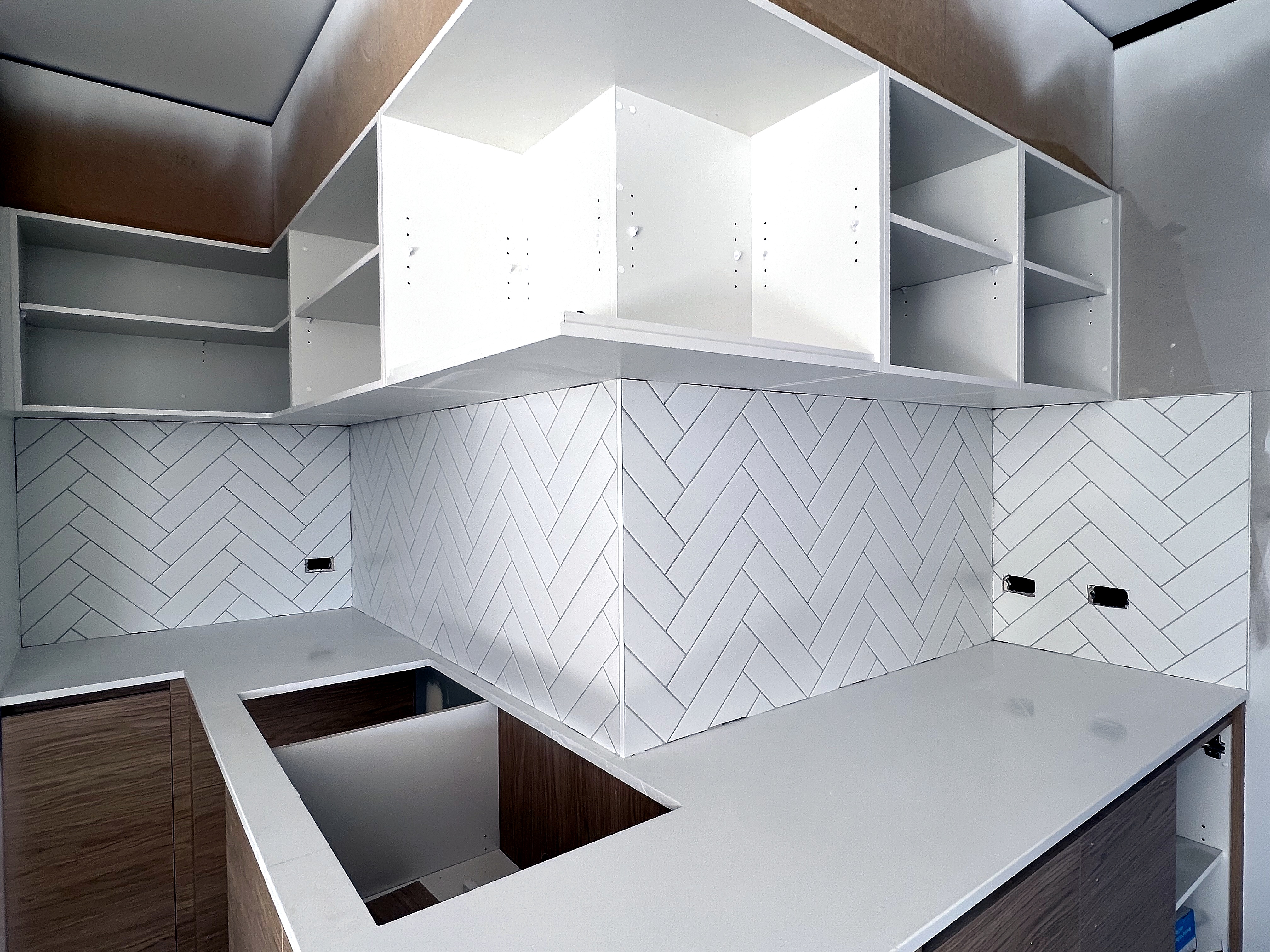 White herringbone splashback tiling completed by LYY Tiling & Waterproofing