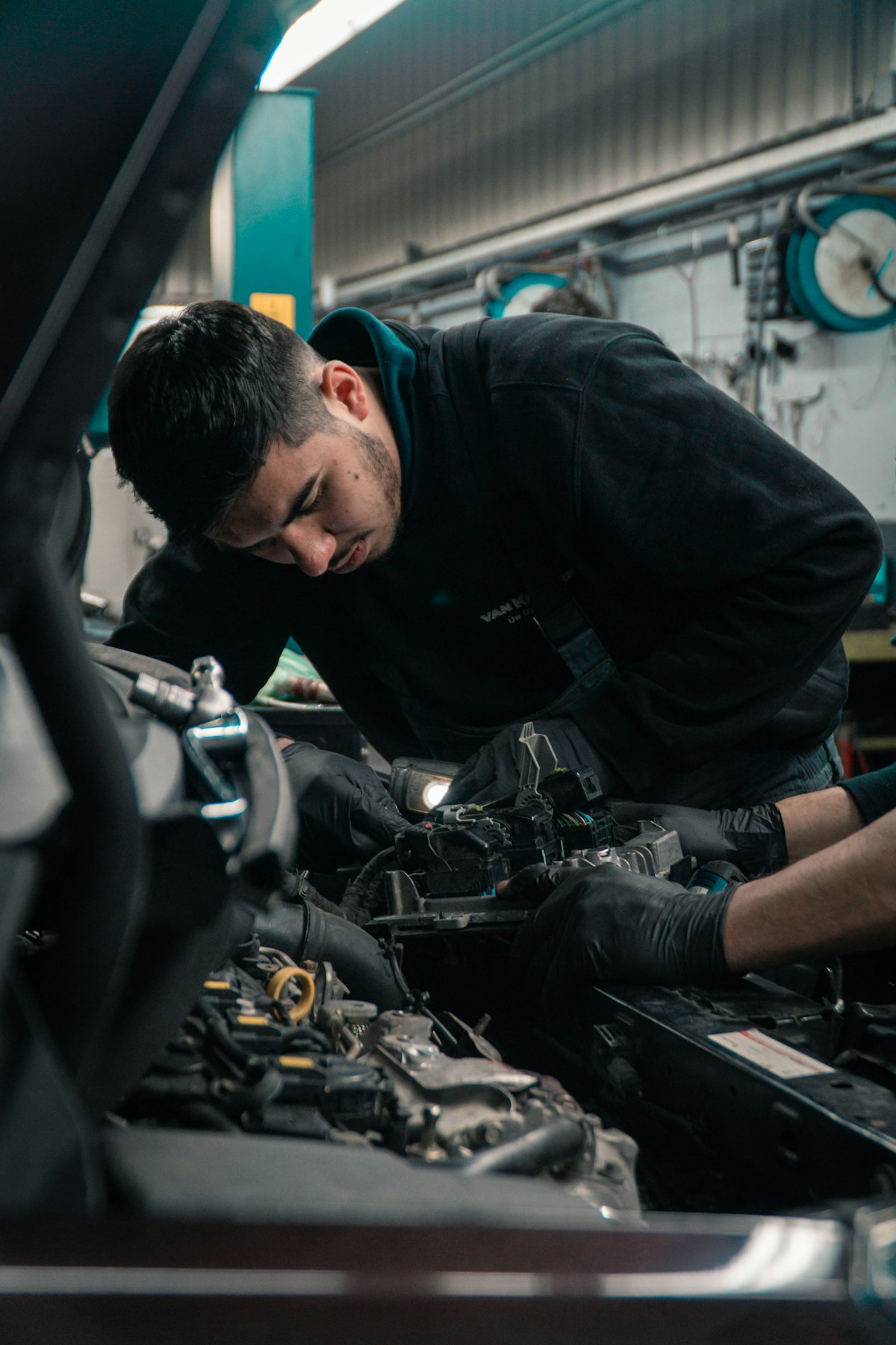 Mechanic inspecting a commercial vehicle engine in a professional garage