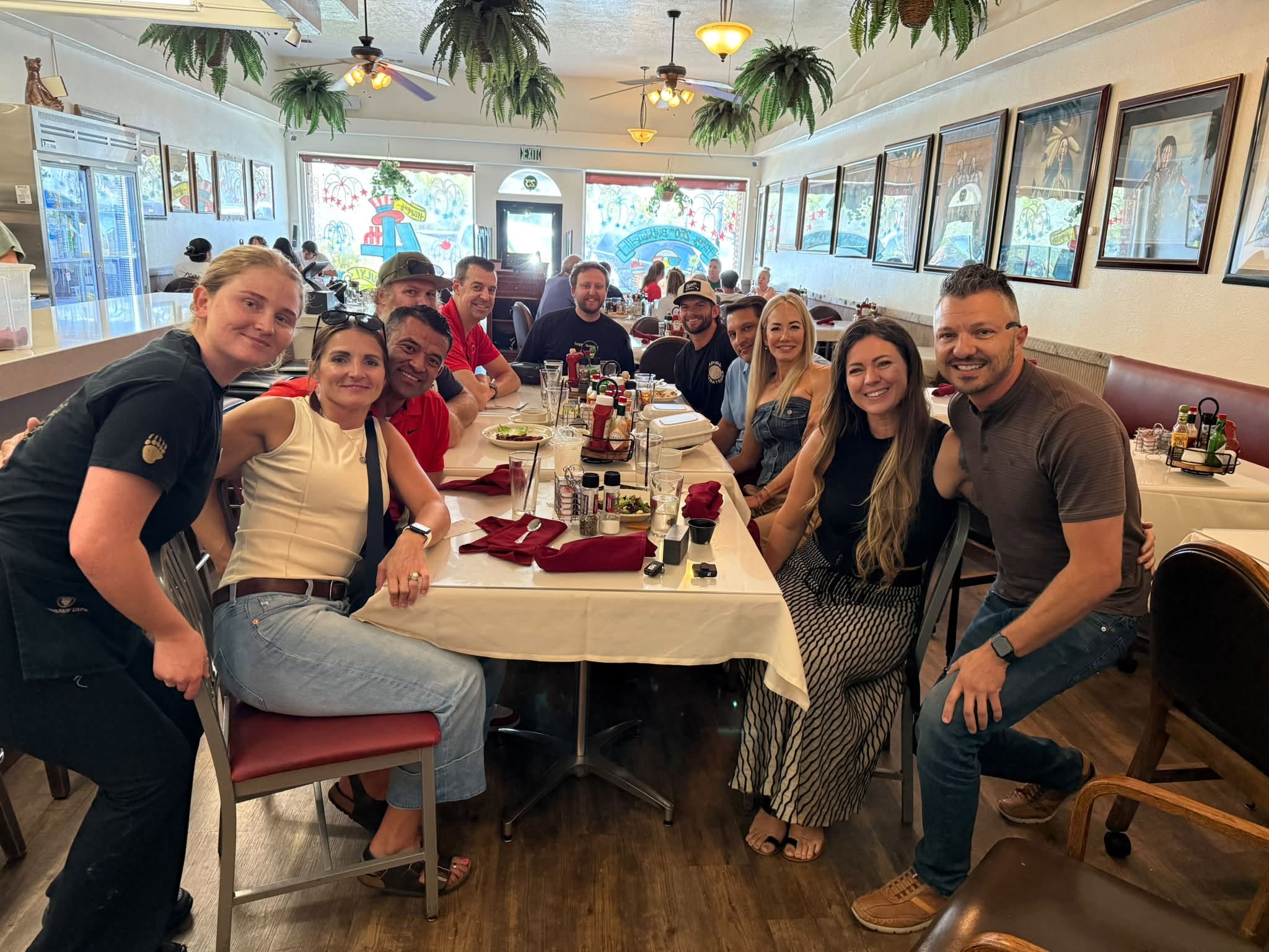 100 Club members gathered together at a restaurant table in St. George, Utah