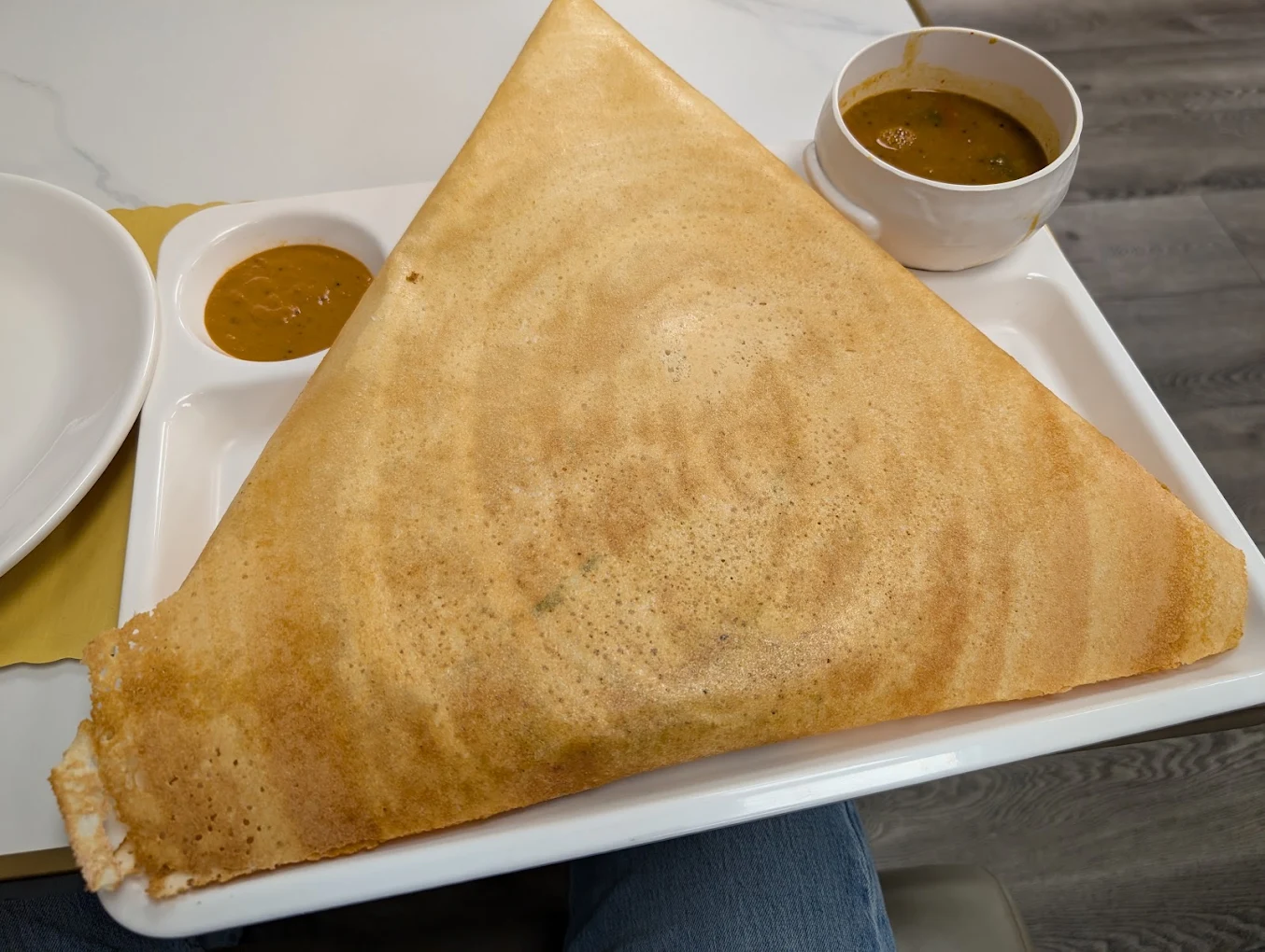 Massive golden crisp dosa served with sambar and chutney at Honest Restaurant