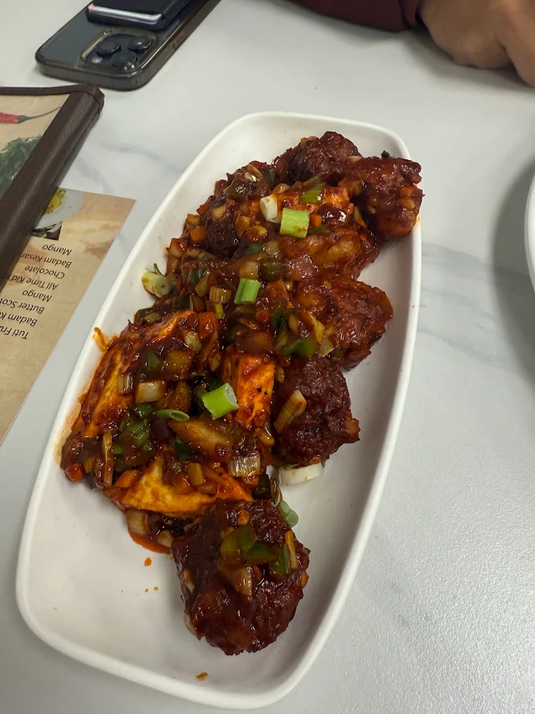 Sizzling Indo-Chinese Chilli Paneer Manchurian with scallions and rich savory sauce