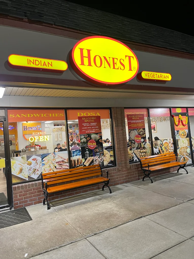 Honest Restaurant glowing sign and storefront at night in St. Peters